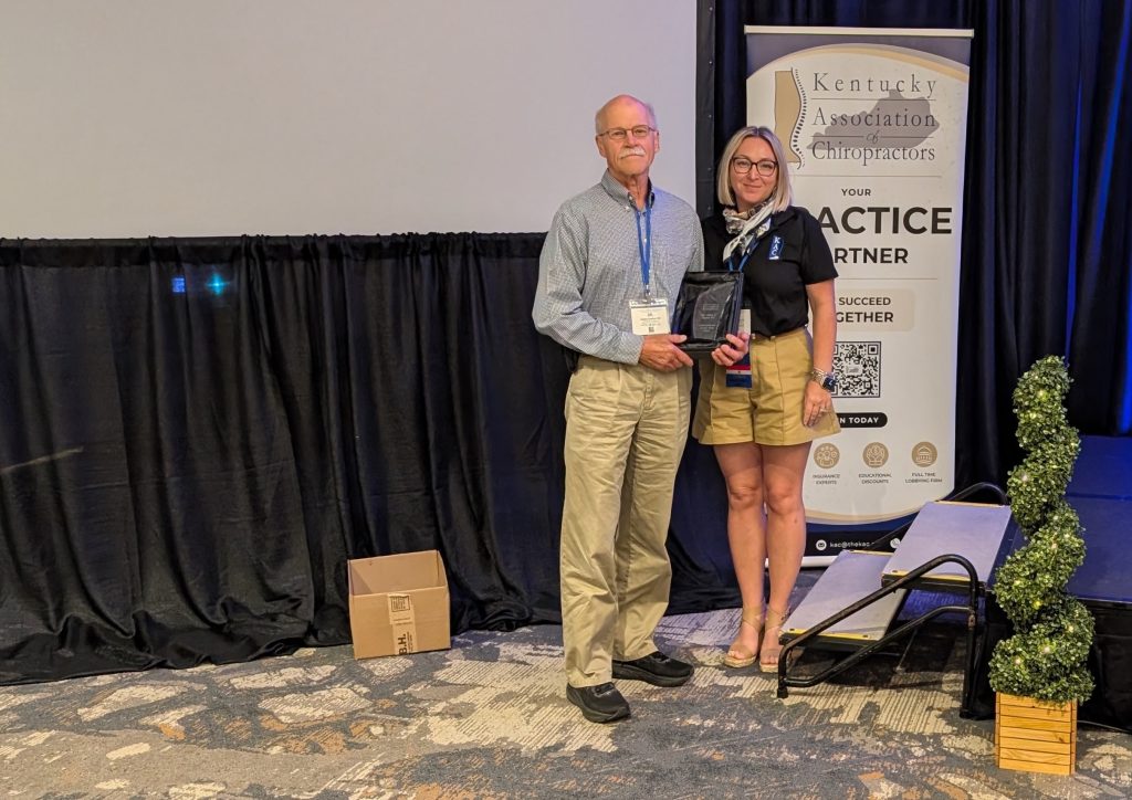 Dr. James Taylor receiving the 2025 Kentucky Chiropractor of the Year award